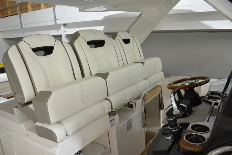 Slide: The Image of 2024 Tiara Yachts 34 LS interior with luxurious seating and modern helm controls. - 53