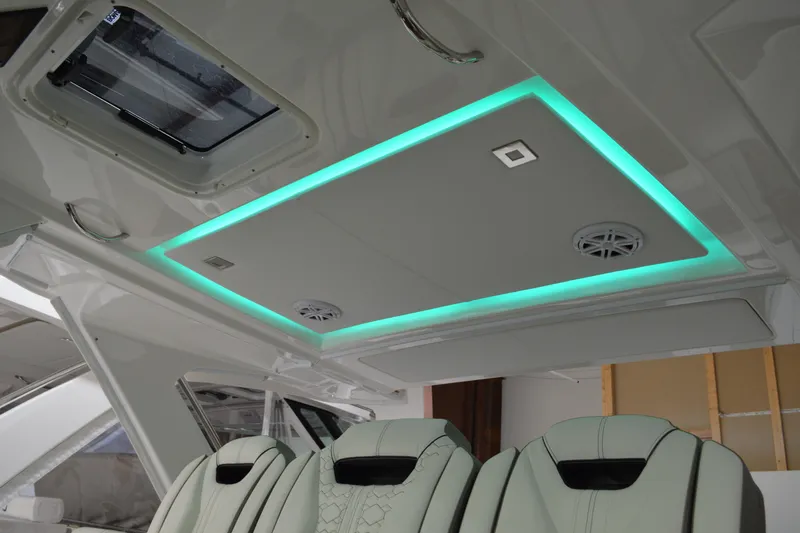 Slide: The Image of 2024 Tiara Yachts 34 LS interior with modern lighting and luxurious seating. - 57
