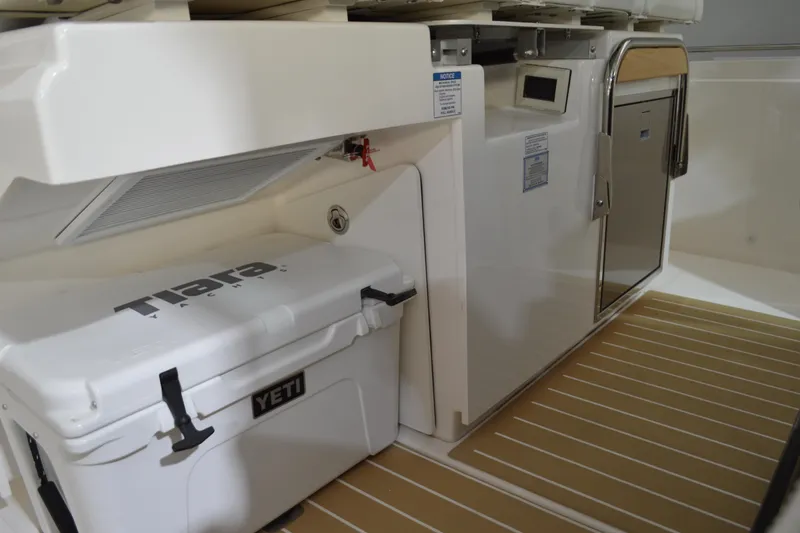 Slide: The Image of 2024 Tiara Yachts 34 LS interior with YETI cooler and storage compartment. - 60