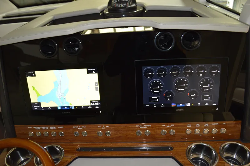 Slide: The Image of 2024 Tiara Yachts 34 LS dashboard with dual Garmin displays and navigation controls. - 64