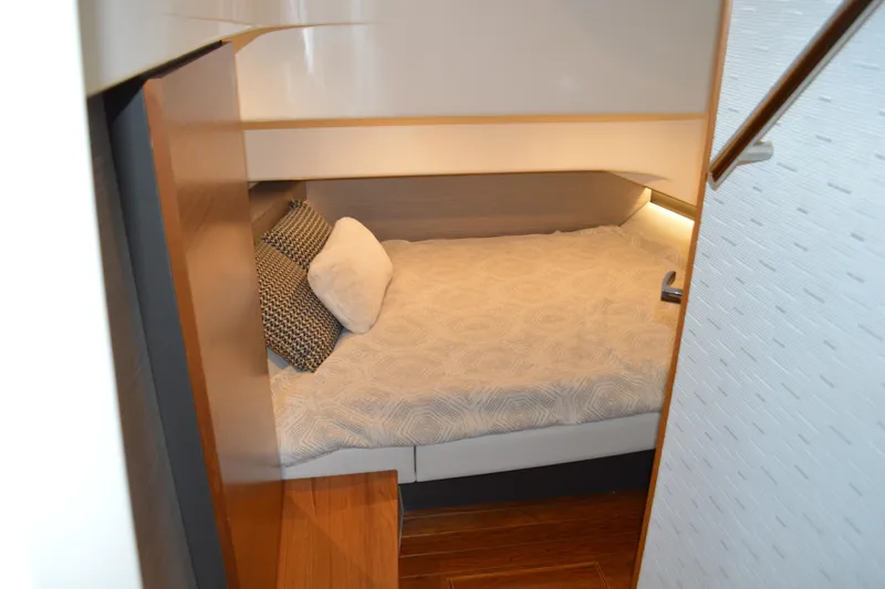 Slide: The Image of Cozy cabin interior of 2024 Tiara Yachts 34 LS with modern bedding and ambient lighting. - 67