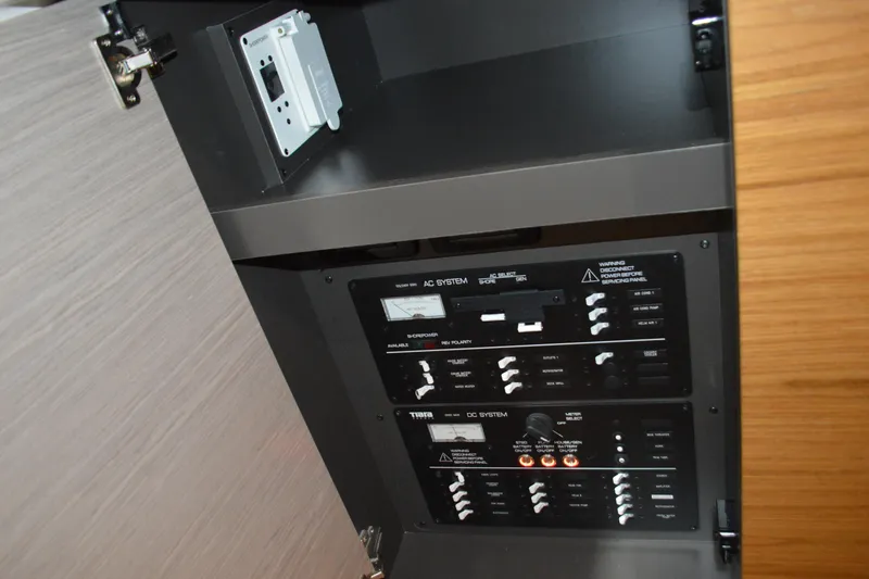 Slide: The Image of Electrical panel inside 2024 Tiara Yachts 34 LS, showcasing AC and DC systems. - 70