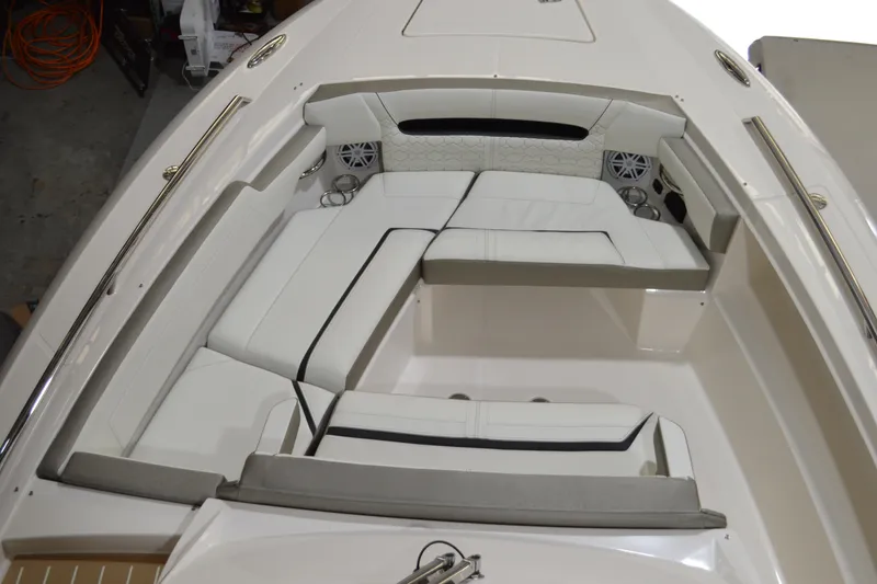 Slide: The Image of 2024 Tiara Yachts 34 LS boat interior with white cushioned seating and cup holders. - 8