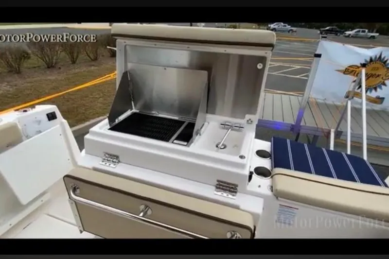 Slide: The Image of 2023 Ranger Tugs R-27 boat with outdoor grill and seating area. - 10