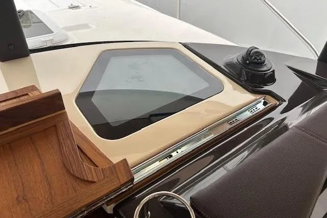 Slide: The Image of 2023 Ranger Tugs R-27 boat interior with navigation equipment and wooden accents. - 15
