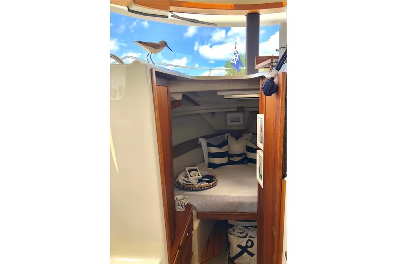 Slide: The Image of Cozy interior of 2023 Ranger Tugs R-27 boat with nautical decor and cushions. - 24