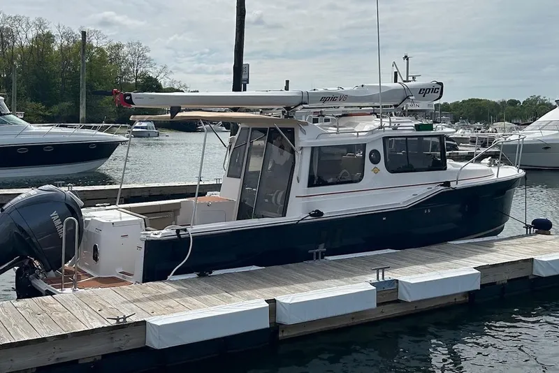 Slide: The Image of 2023 Ranger Tugs R-27 boat docked at marina with Yamaha outboard motor. - 3