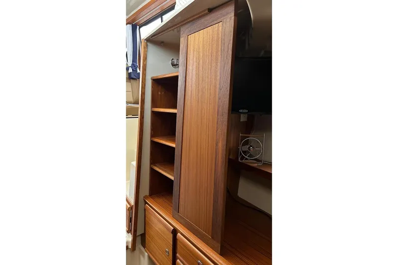 Slide: The Image of 2023 Ranger Tugs R-27 interior with wooden cabinet and shelves. - 31