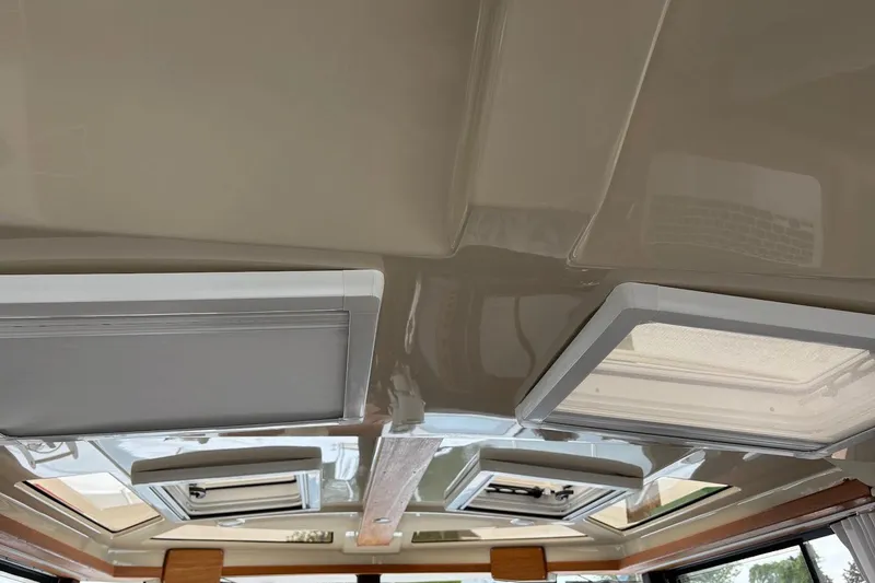 Slide: The Image of Interior ceiling view of 2023 Ranger Tugs R-27 with skylights and modern design. - 34