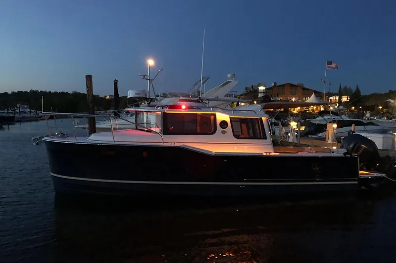 Slide: The Image of 2023 Ranger Tugs R-27 boat docked at night with lights on. - 7