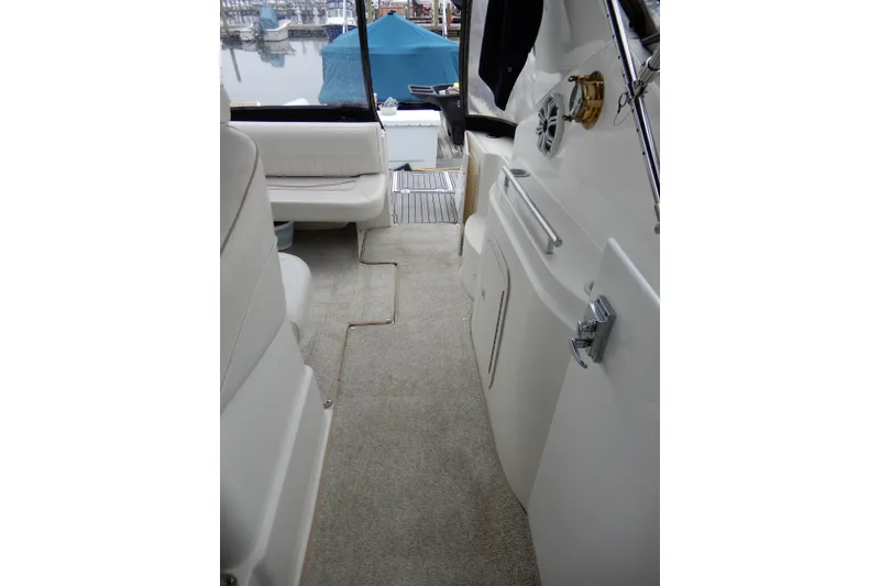 Slide: The Image of 1999 Cruisers Yachts 3075 Rogue interior with seating and marina view. - 10