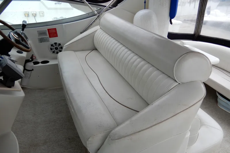 Slide: The Image of 1999 Cruisers Yachts 3075 Rogue interior with white leather seating and steering area. - 12