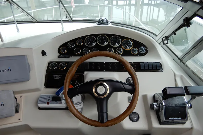 Slide: The Image of 1999 Cruisers Yachts 3075 Rogue dashboard with steering wheel and navigation instruments. - 14