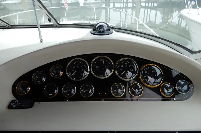 Slide: The Image of Dashboard of a 1999 Cruisers Yachts 3075 Rogue with multiple gauges and controls. - 15
