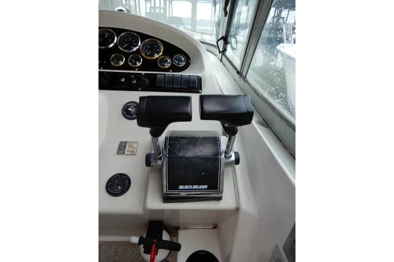 Slide: The Image of 1999 Cruisers Yachts 3075 Rogue helm with Quicksilver throttle controls and instrument panel. - 16