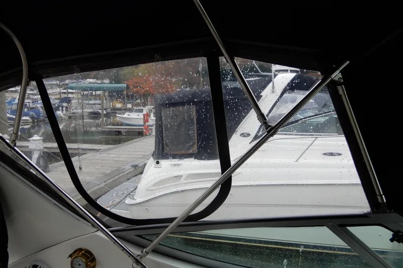 Slide: The Image of View from inside a 1999 Cruisers Yachts 3075 Rogue, overlooking a rainy marina. - 20