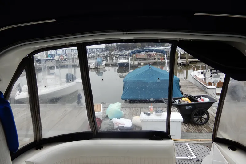 Slide: The Image of 1999 Cruisers Yachts 3075 Rogue interior view, overlooking marina with boats and dock. - 22