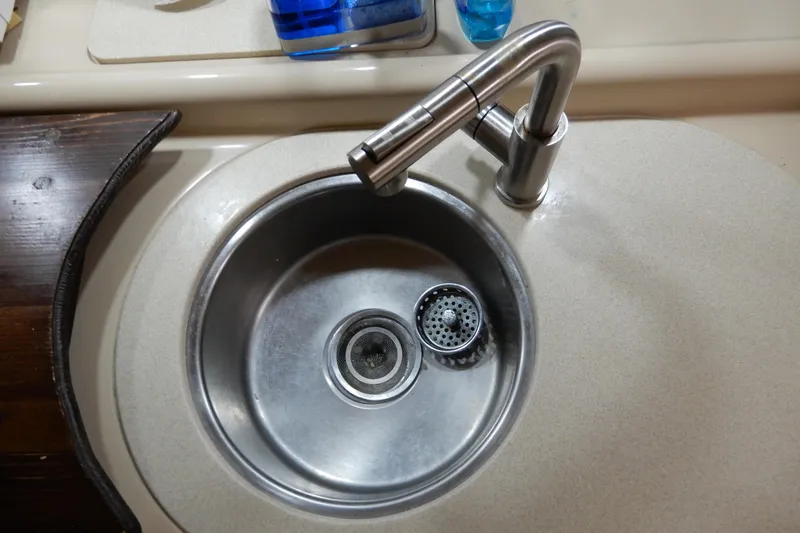 Slide: The Image of Stainless steel sink and faucet in 1999 Cruisers Yachts 3075 Rogue kitchen area. - 32
