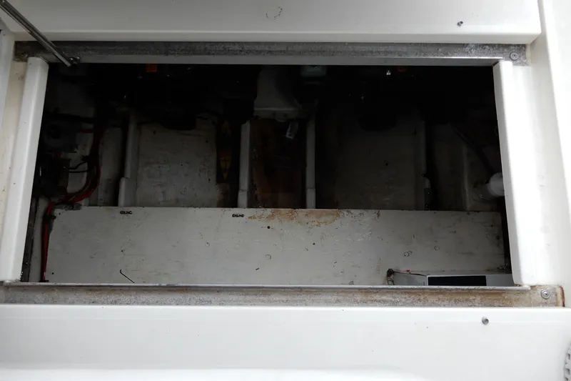 Slide: The Image of Engine compartment of a 1999 Cruisers Yachts 3075 Rogue, showing interior components and wiring. - 45