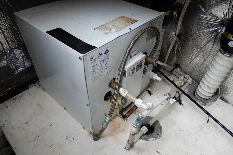 Slide: The Image of 1999 Cruisers Yachts 3075 Rogue engine compartment with mechanical components and piping. - 52