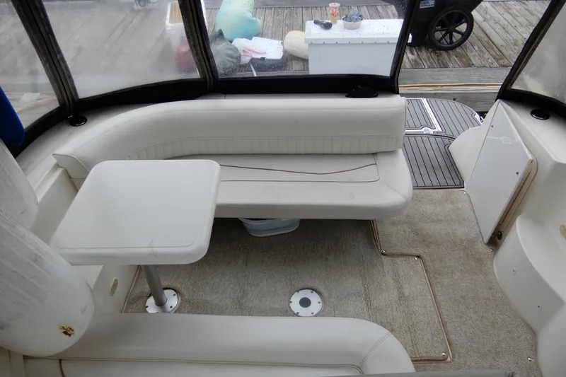 Slide: The Image of 1999 Cruisers Yachts 3075 Rogue interior with white seating and table. - 7