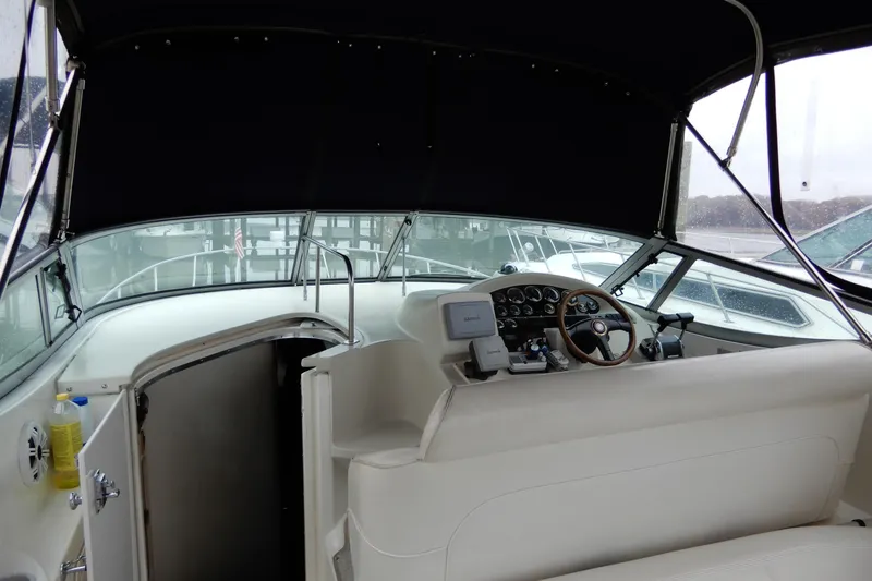 Slide: The Image of 1999 Cruisers Yachts 3075 Rogue cockpit with steering wheel and navigation equipment. - 11