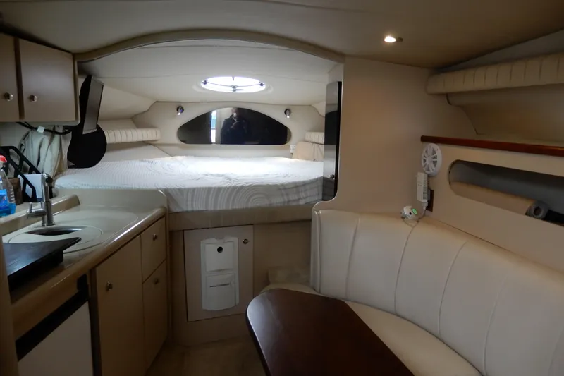 Slide: The Image of 1999 Cruisers Yachts 3075 Rogue interior with bed, kitchenette, and seating area. - 23