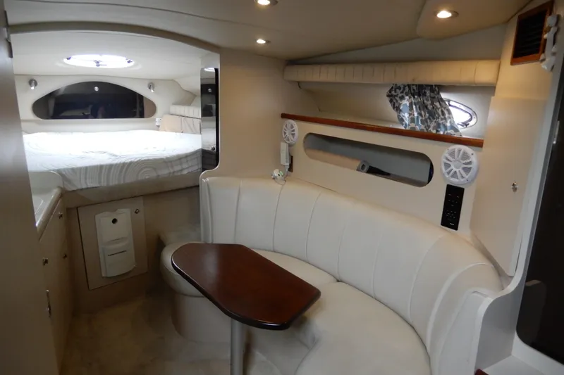 Slide: The Image of 1999 Cruisers Yachts 3075 Rogue interior with cozy seating and bed area. - 24