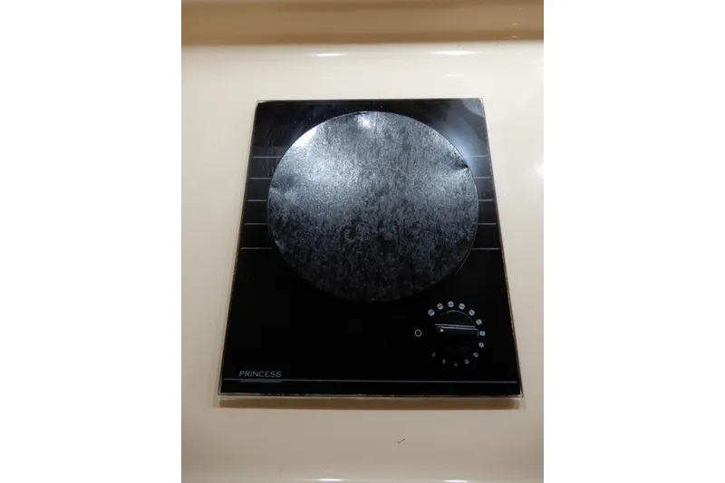 Slide: The Image of Electric stove on 1999 Cruisers Yachts 3075 Rogue, featuring a single burner. - 30