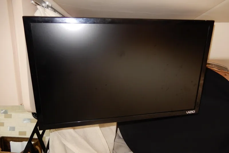 Slide: The Image of Vizio flat-screen TV mounted indoors, part of a 1999 Cruisers Yachts 3075 Rogue. - 33