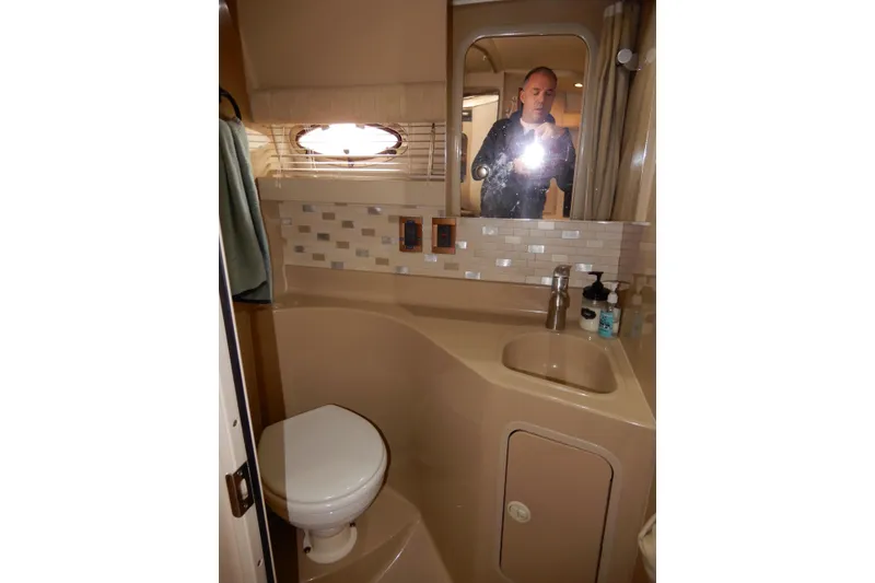 Slide: The Image of 1999 Cruisers Yachts 3075 Rogue bathroom with sink, toilet, and mirror. - 34
