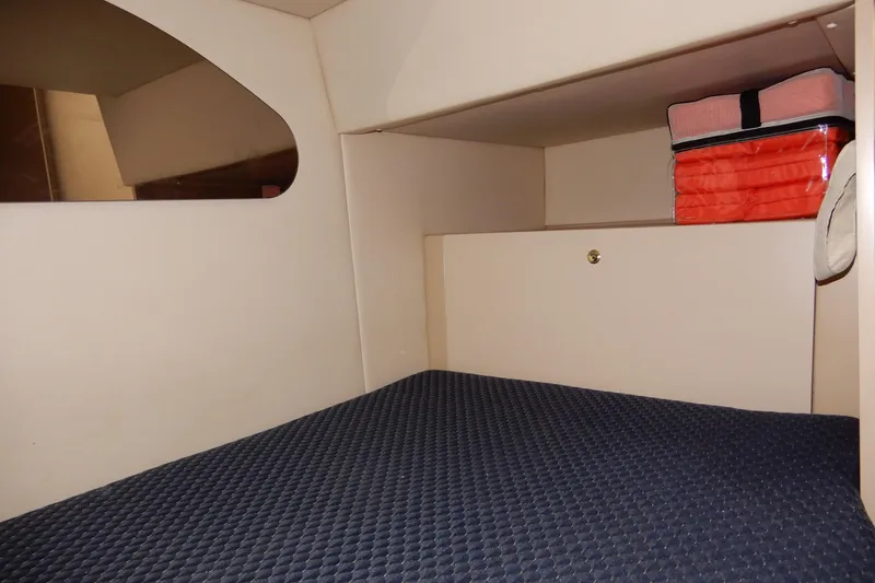 Slide: The Image of 1999 Cruisers Yachts 3075 Rogue cabin interior with storage and bedding. - 38