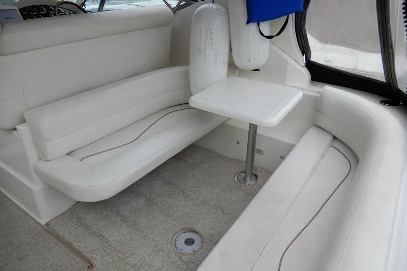 Slide: The Image of 1999 Cruisers Yachts 3075 Rogue interior with white seating and table. - 8