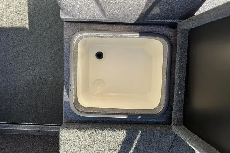 Slide: The Image of Livewell compartment in a 2014 Stratos 386 XF boat, featuring a clean interior. - 10