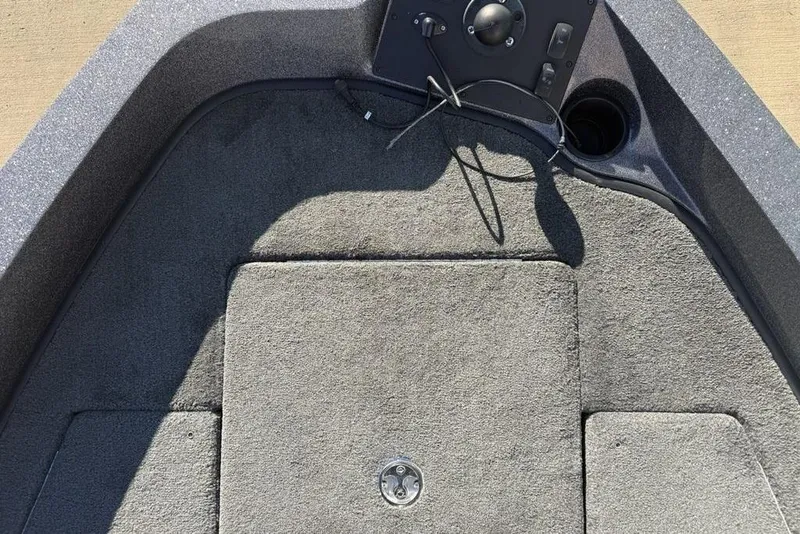 Slide: The Image of Interior view of a 2014 Stratos 386 XF boat, featuring carpeted flooring and control panel. - 11