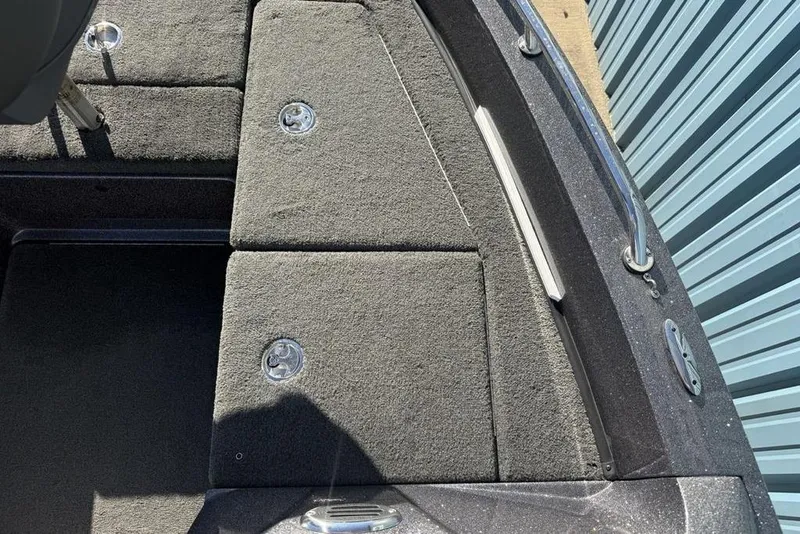 Slide: The Image of 2014 Stratos 386 XF boat deck with carpeted storage compartments and metal handles. - 12