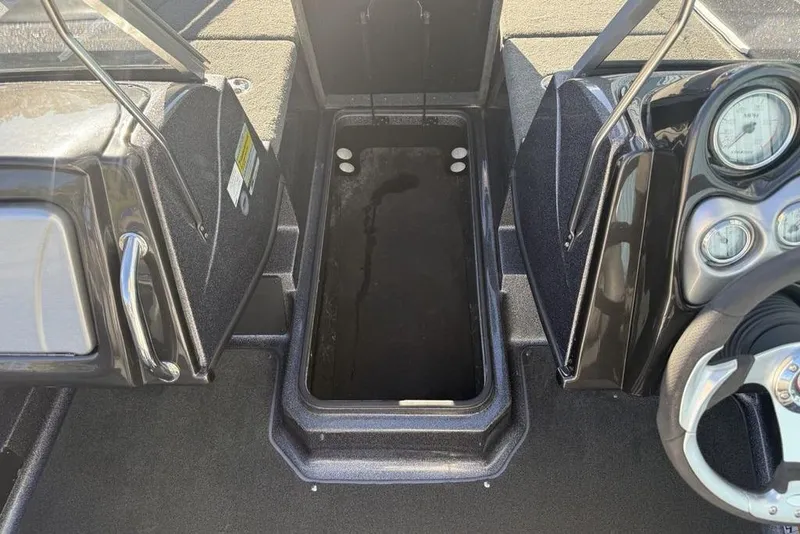 Slide: The Image of 2014 Stratos 386 XF boat interior with open storage compartment and dashboard controls. - 13