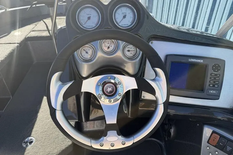 Slide: The Image of Steering wheel and dashboard of 2014 Stratos 386 XF boat with gauges and Lowrance display. - 16
