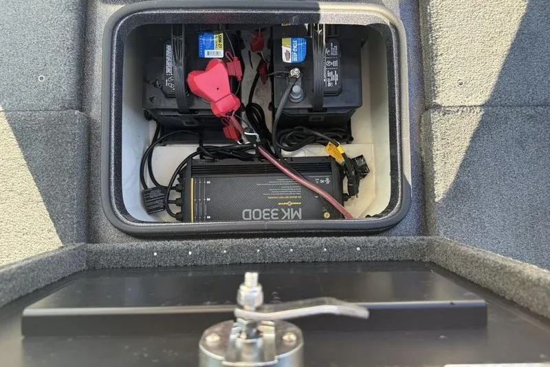 Slide: The Image of Battery compartment of a 2014 Stratos 386 XF boat with dual batteries and charger. - 17