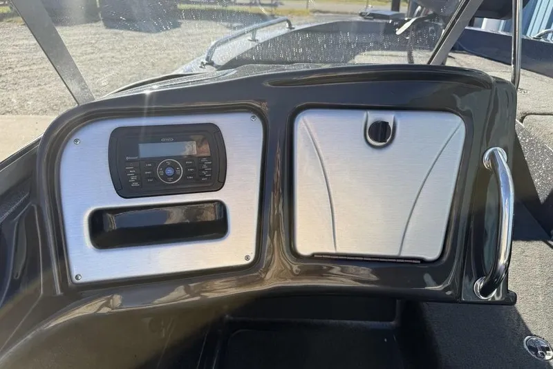 Slide: The Image of Dashboard of 2014 Stratos 386 XF boat with stereo system and storage compartment. - 20