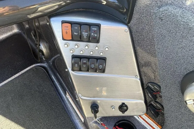 Slide: The Image of Control panel of a 2014 Stratos 386 XF boat with various switches and buttons. - 21