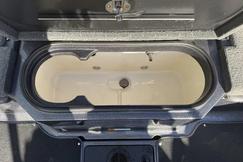 Slide: The Image of Open storage compartment in a 2014 Stratos 386 XF boat. - 22