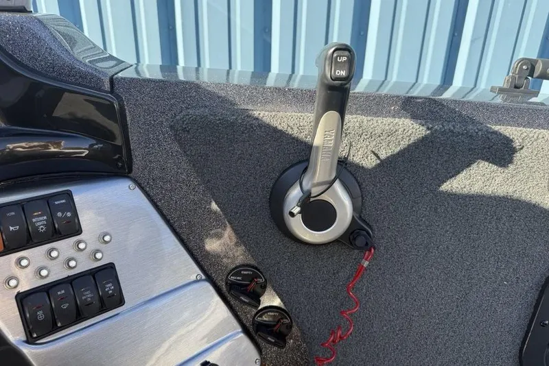 Slide: The Image of Control panel of a 2014 Stratos 386 XF boat with throttle and switches. - 24