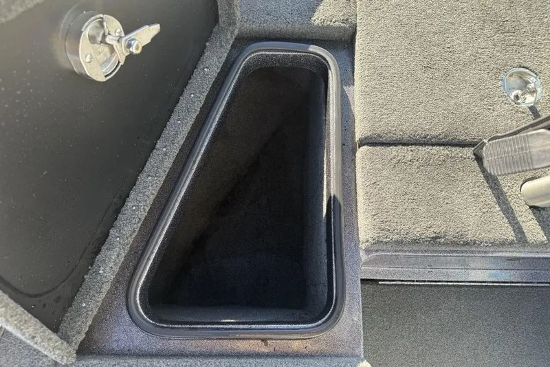 Slide: The Image of 2014 Stratos 386 XF boat storage compartment with lock and carpeted interior. - 8