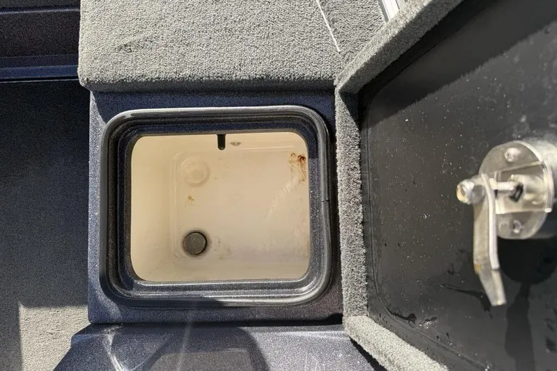 Slide: The Image of 2014 Stratos 386 XF boat storage compartment with open lid and latch. - 9