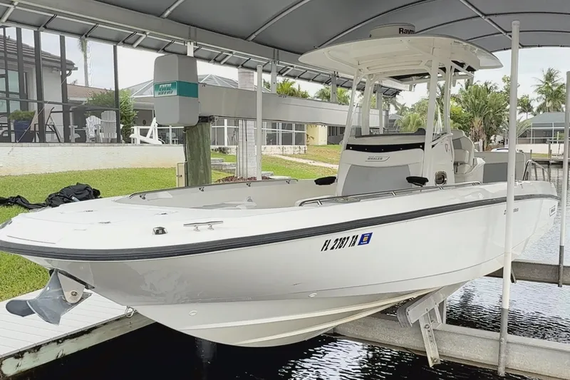 Slide: The Image of 2015 Boston Whaler 270 Dauntless boat docked under a canopy. - 0