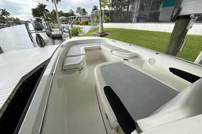 Slide: The Image of 2015 Boston Whaler 270 Dauntless boat interior with seating, dockside view. - 15