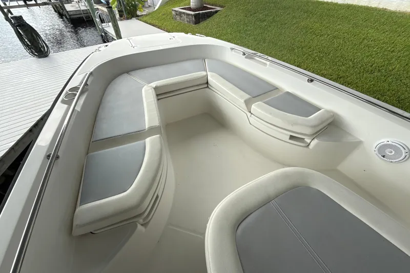 Slide: The Image of 2015 Boston Whaler 270 Dauntless boat interior with cushioned seating and speaker. - 18