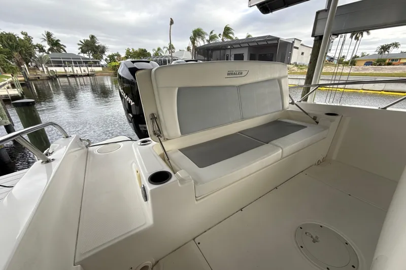 Slide: The Image of 2015 Boston Whaler 270 Dauntless boat interior with seating and water view. - 22