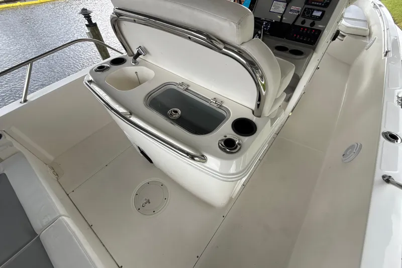 Slide: The Image of 2015 Boston Whaler 270 Dauntless boat interior with seating and control panel. - 26